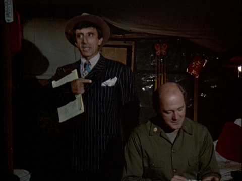 Klinger standing next to Charles, dressed in a zoot suit