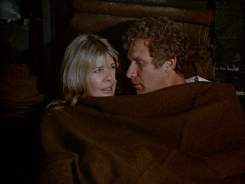 Still from the M*A*S*H episode Bombed showing Margaret and Trapper under a blanket.