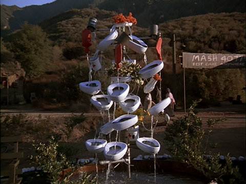 Still from the M*A*S*H episode Give 'Em Hell Hawkeye showing the 4077th's wonderful fountain.