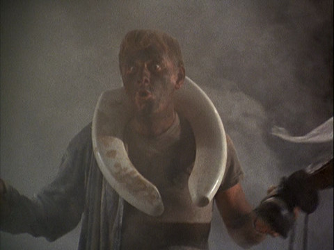 Henry covered in soot with a toliet seat around his neck