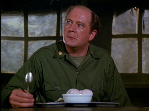 Charles in the mess tent with a bowl of ice cream