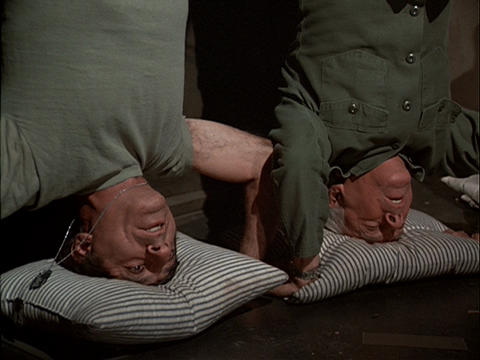 Klinger and Colonel Potter standing on their heads