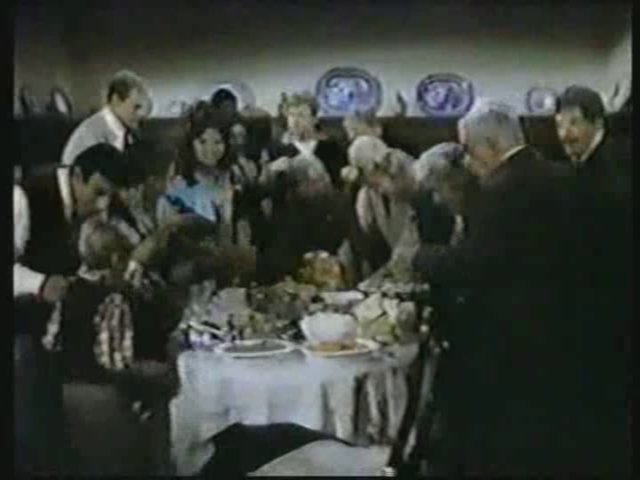 Still from the AfterMASH episode Thanksgiving of '53 showing everyone gathered around the turkey.