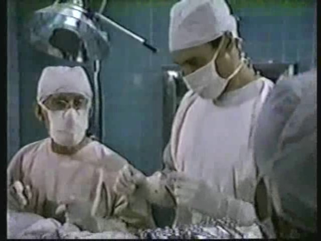 Still from the AfterMASH episode Fallout showing Potter and Dr. Pfeiffer in surgery.