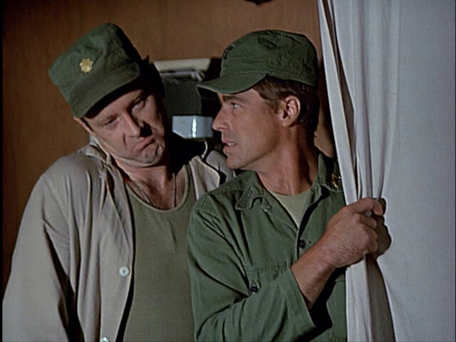 Still from the MASH episode Deal Me Out showing Frank and Colonel Flagg.
