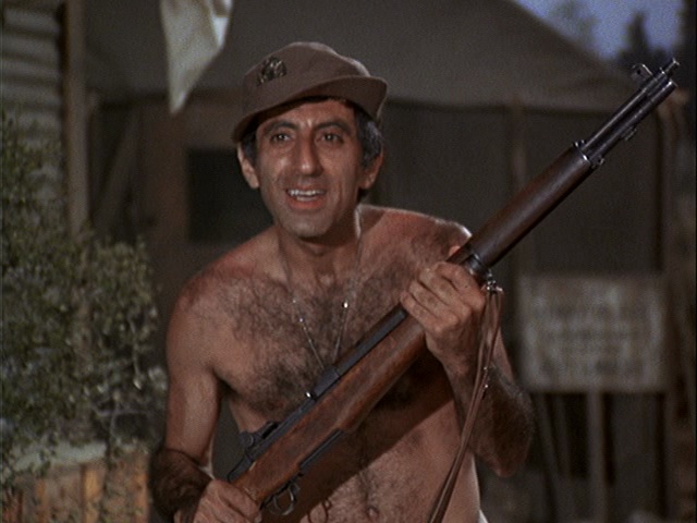 Still from the MASH episode Chief Surgeon Who? showing Jamie Farr clearly wearing clothes.