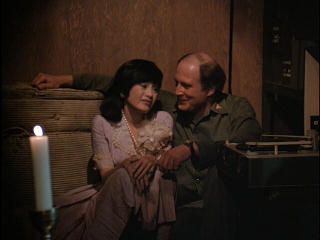 Still from the M*A*S*H episode Ain't Love Grand showing Charles listening to music.