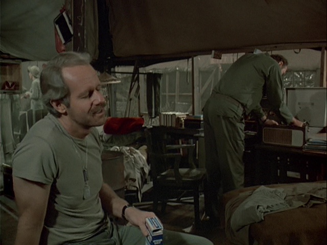 Still from the M*A*S*H episode Friends and Enemies showing Charles listening to music.